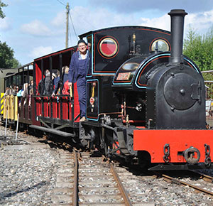 Image shows a train driver and his passengers on one of the heritage trains at Apedale Valley Light Railway, Newcastle-under-Lyme, Staffordshire