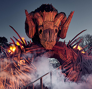 The Wicker Man, surrounded by smoke and flames, as night falls at Alton Towers Resort, Staffordshire