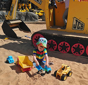 Boy playing in the giant sand pit at National Forest Adventure Farm, Staffordshire. Image courtsey Dirt, Diggers & Dinosaurs