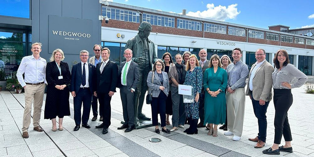 Group of people including VisitEngland's Advisory Board, Staffordshire & Stoke-on-Trent LVEP members and senior personnel from Wedgwood standing next to a statue of Josiah Wedgwood outside the World of Wedgwood visitor attraction, Stoke-on-Trent, Staffordshire.