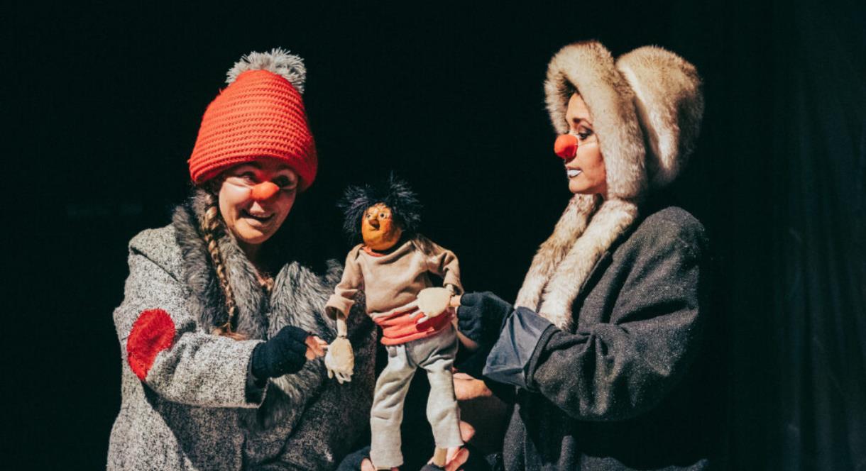 Artists performing with puppet