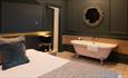 Double bedroom with roll top bath