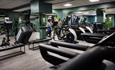 The well-equipped gym at Hoar Cross Hall, with a couple of guests pushing themselves on the exercise bikes