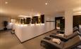 The Nordic Suite at Hoar Cross Hall, with a row of comfy-looking day beds and candles and low-level lighting to set the mood