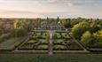 A drone shot of Hoar Cross Hall at sunrise, showing the perfectly manicured grounds and the beautiful surroundings