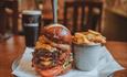 A burger and chips, with a nicely-poured pint of Guinness in the background