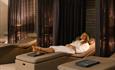 A visitor relaxes on one of the day beds in the spa at Hoar Cross Hall
