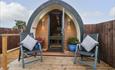 Outside The Pod at Bank House Farm - a glamping pod with two deckchairs outside for soaking up the sun