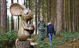 Image shows a sculpture of the Mouse from The Gruffalo, sitting on a tree stump with a nut