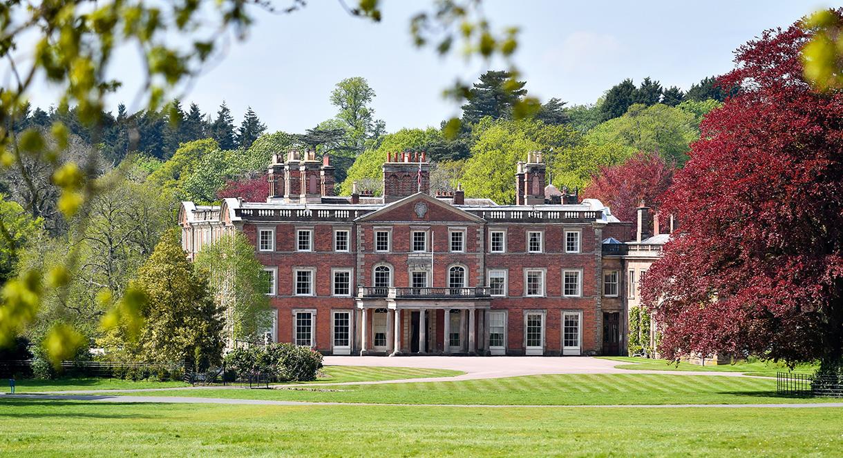 Image shows the House at Weston Park, seen from afar on a sunny day